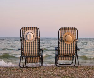 Rear view beach chairs on seashore.